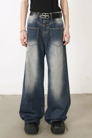 Faded wash palazzo jeans in medium blue denim with a wide leg and distressed details.