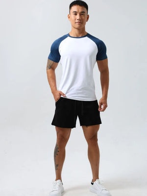 Raglan sleeve t-shirt in white with navy sleeves and crew neck.