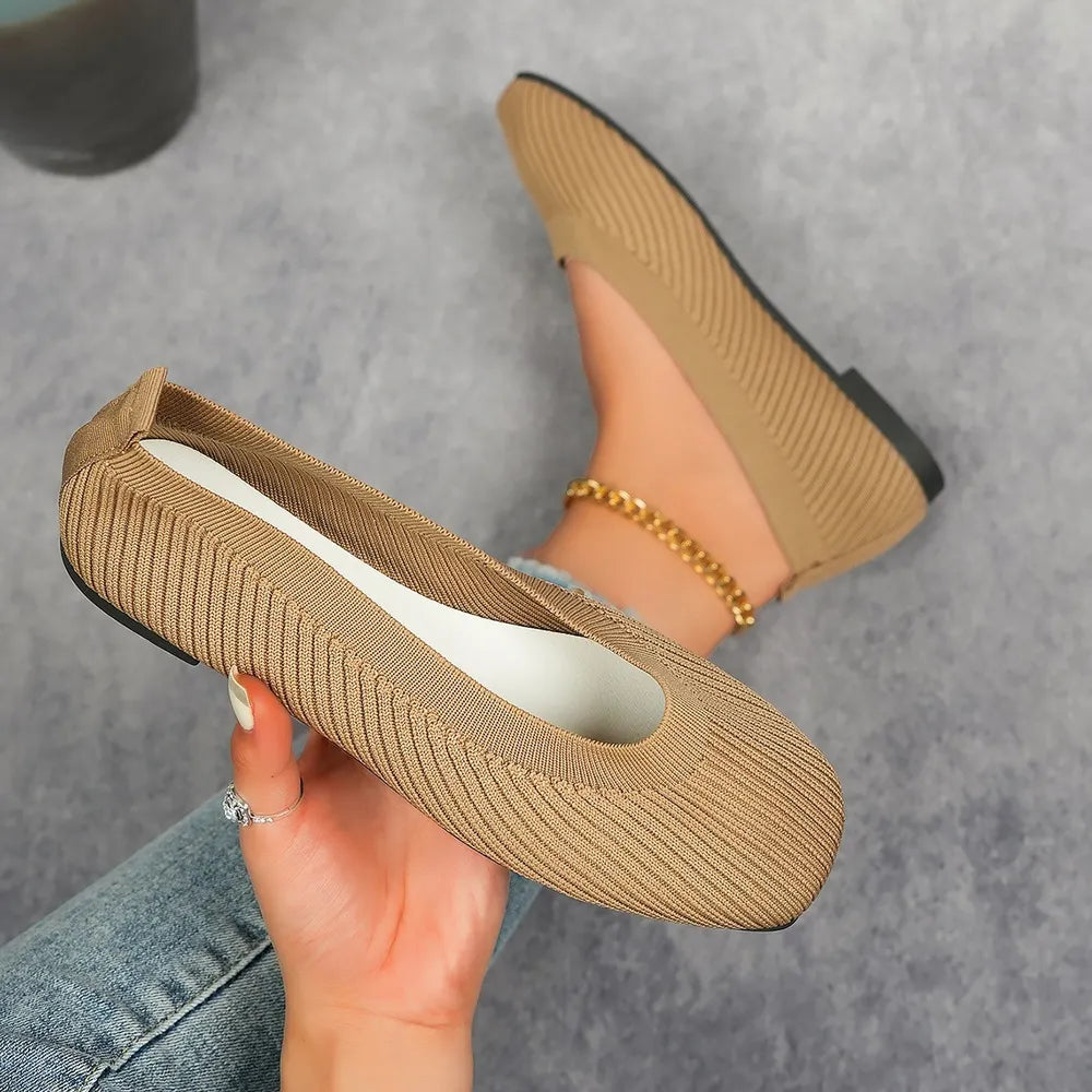 Beige knit square toe flats with a ribbed texture and a gold ankle bracelet.