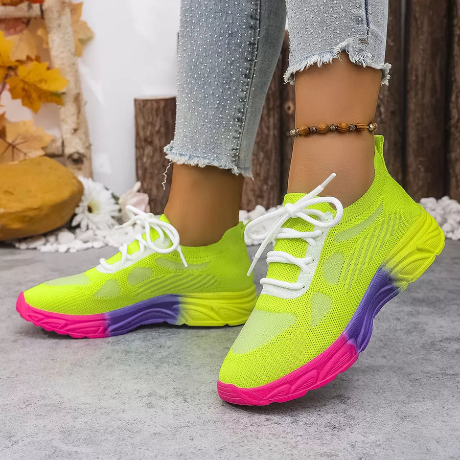 Breathable mesh lace-up sneakers in neon yellow with pink and purple sole.