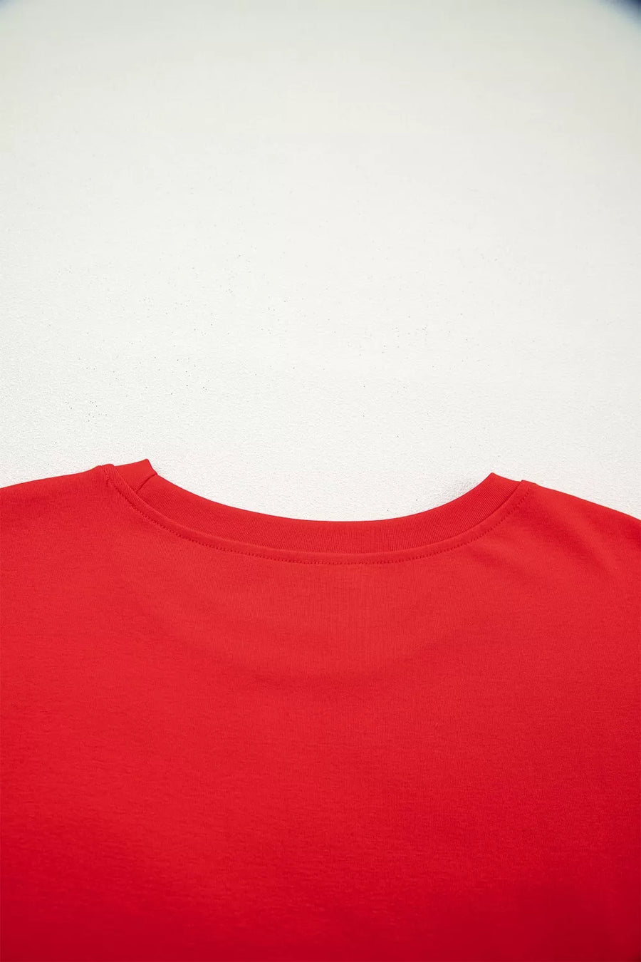 Red cotton mini dress with crew neck and short sleeves.
