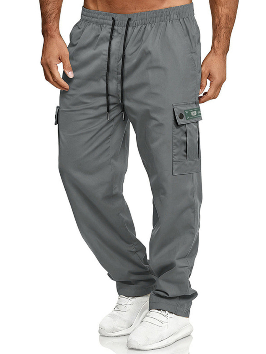 Gray cargo pants with adjustable waist and drawstring, featuring multiple pockets.
