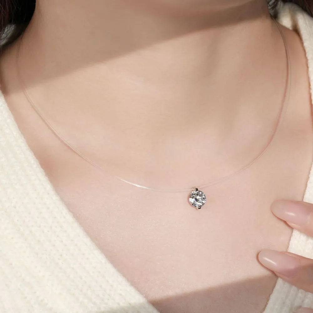 Silver floating moissanite necklace with a clear illusion chain, showcasing a single sparkling 1 ct D color grade pendant.