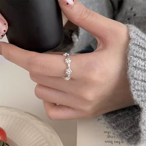 Silver ring featuring flower motif and floral