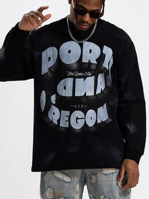 Black oversized long-sleeve tee with "PORTLAND OREGON The Rose City USA" graphic print.