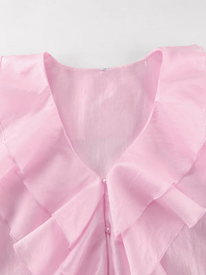 Pink ruffle trim blouse with pearl buttons and V-neckline.