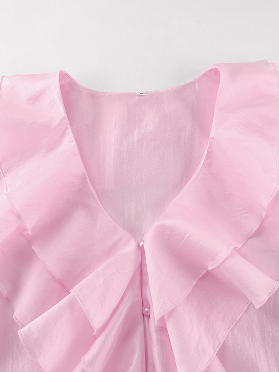 Pink ruffle trim blouse with pearl buttons and V-neckline.