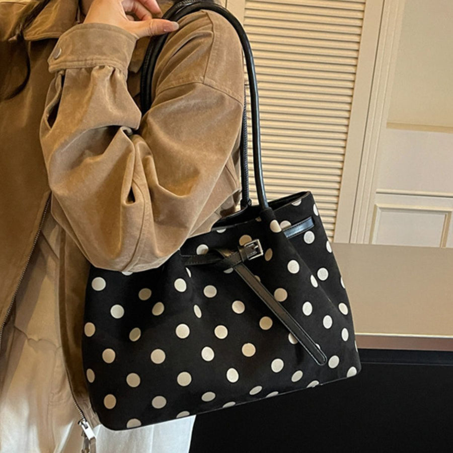 cream shoulder bag featuring shoulder strap and polka dot