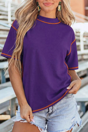 Purple cotton t-shirt with contrast orange stitching and short sleeves.