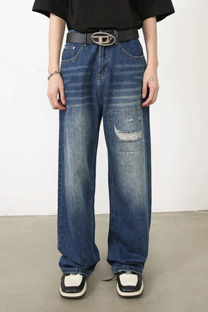 Baggy patchwork denim jeans in medium vintage wash with distressed details.