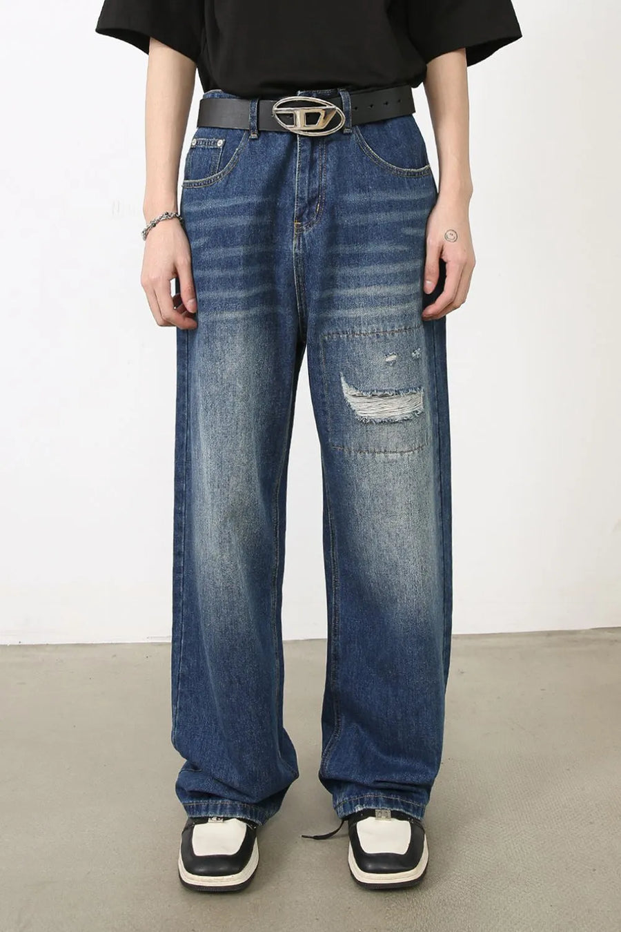 Baggy patchwork denim jeans in medium vintage wash with distressed details.
