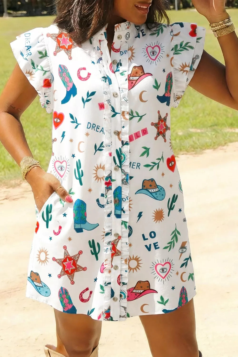 White western print mini dress with flutter sleeves, button-down front, and ruffle trim.