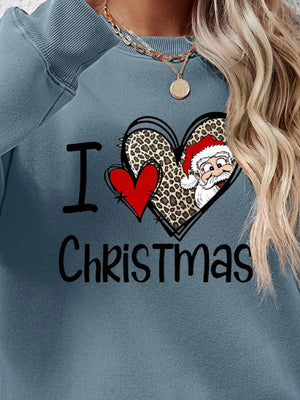 Light blue crewneck sweatshirt with "I Love Christmas" graphic featuring Santa and leopard print heart.