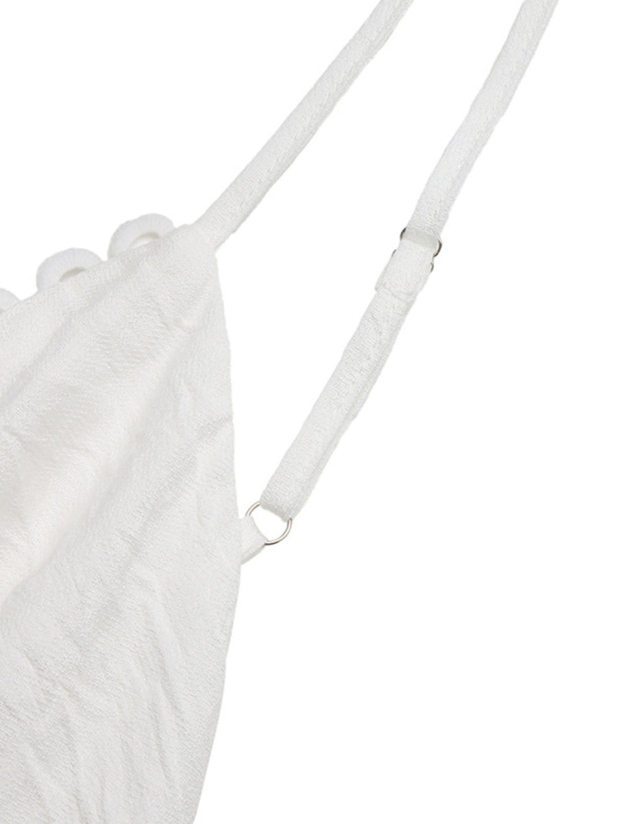 White lace tiered maxi dress with adjustable spaghetti straps and scalloped trim detail.
