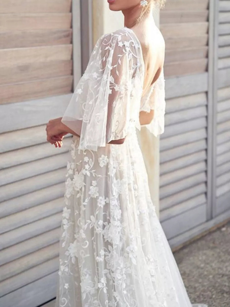 White lace flutter sleeve v-neck dress with floral embroidery and open back.