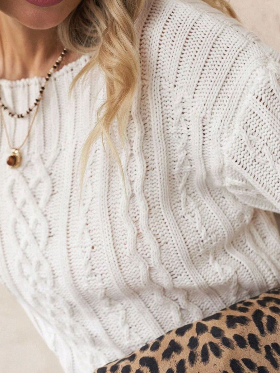 White pullover sweater featuring cable-knit and cable knit