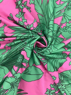 Tropical floral ruched maxi dress in pink with green leaves and flowers.