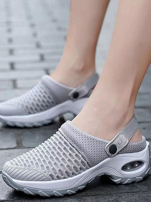 Light gray air cushion mesh slingback clogs with adjustable heel strap and white sole.