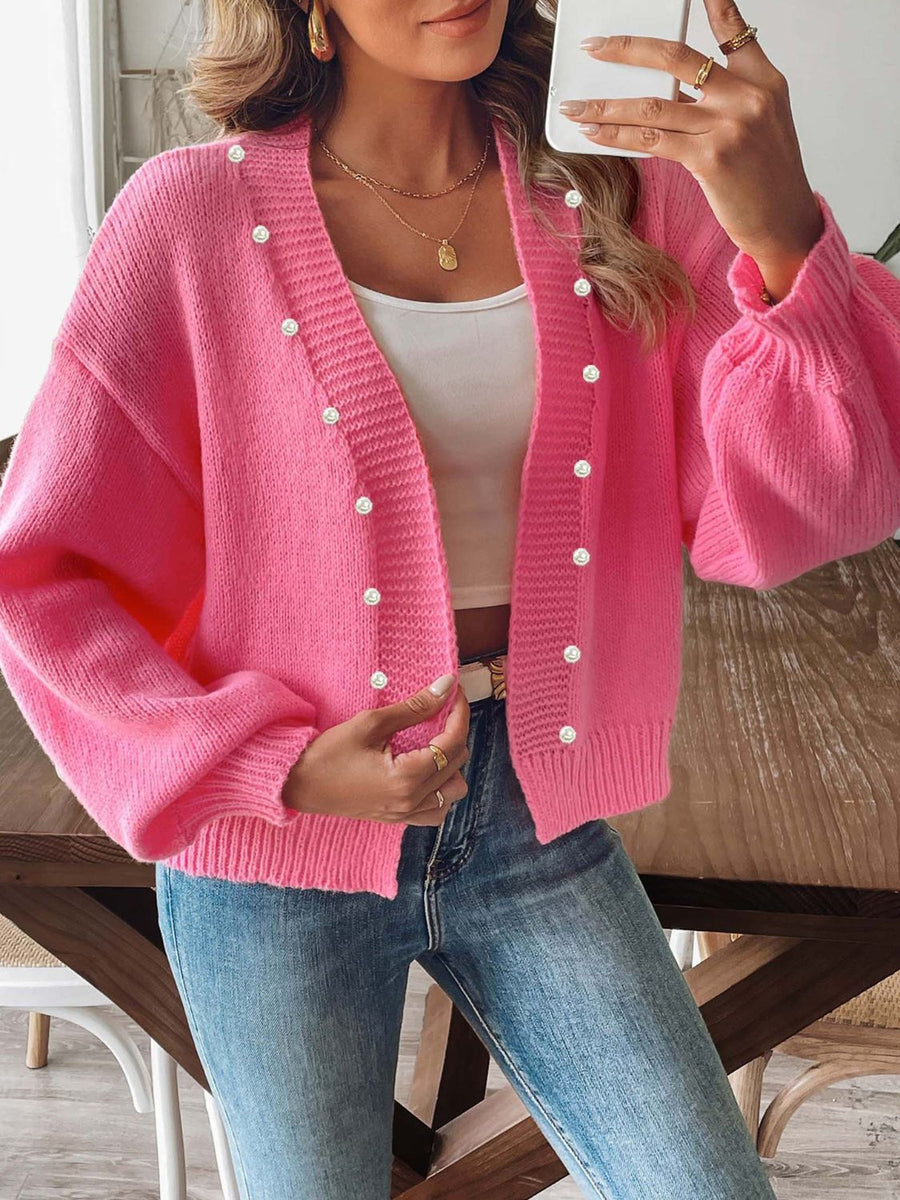 Fuchsia pink bubble sleeve cardigan with pearl buttons and V-neck.