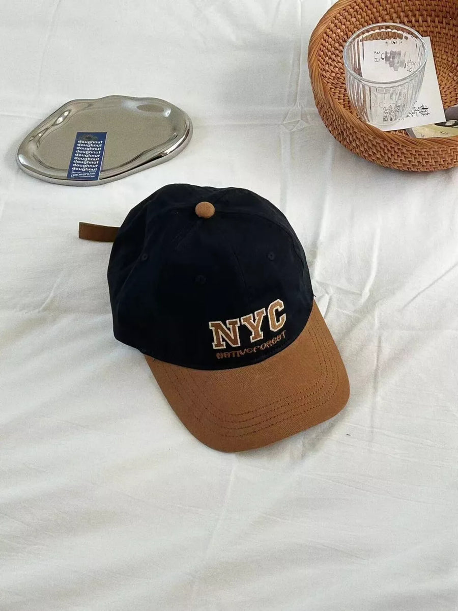 Black cotton baseball cap with brown brim and NYC embroidery