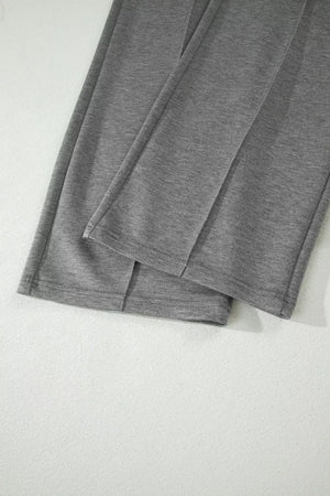 Dark gray wide-leg pants with stitched front detail and cuffed hems.