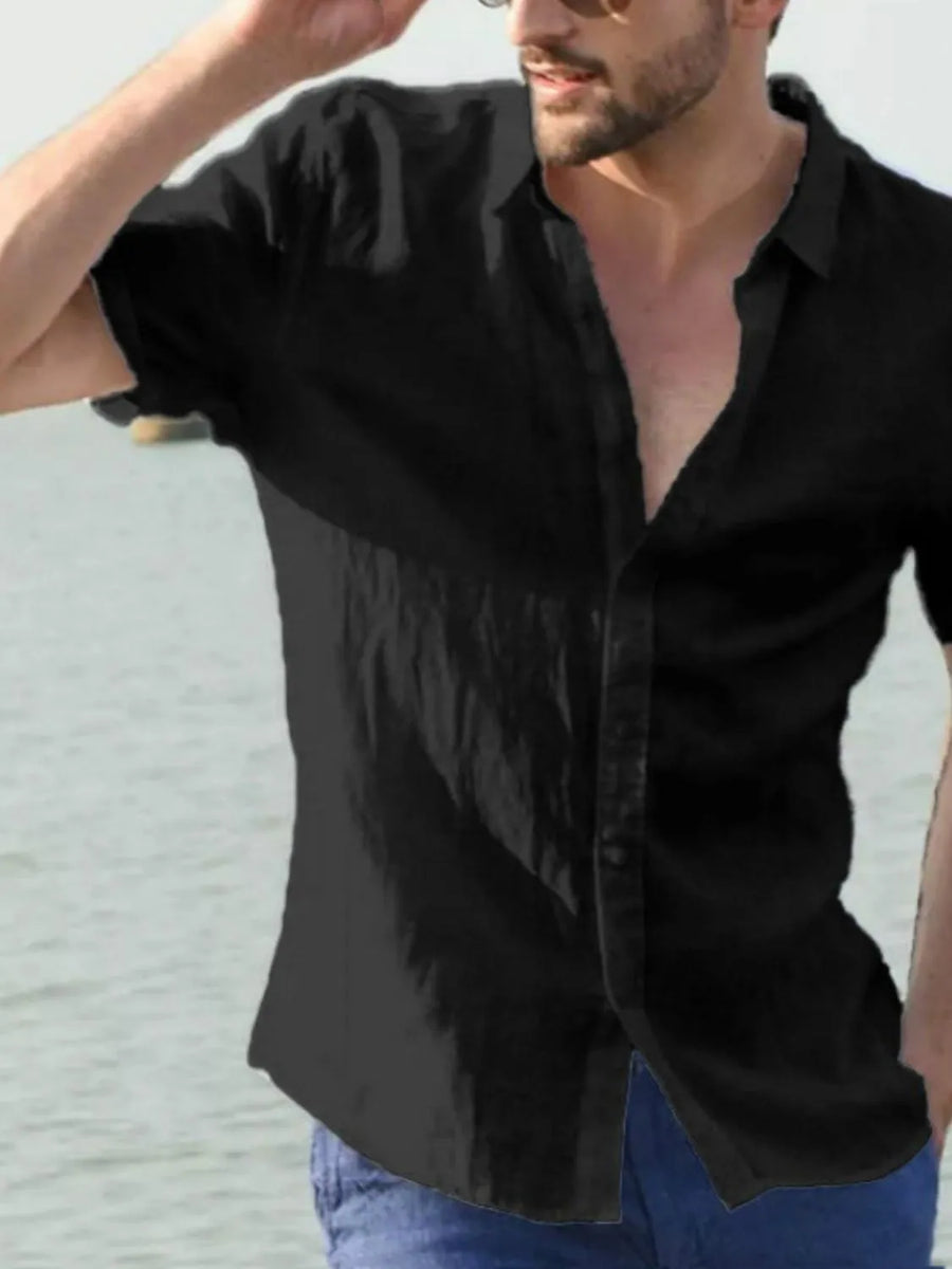 Black linen resort shirt with short sleeves and button front, styled open collar.
