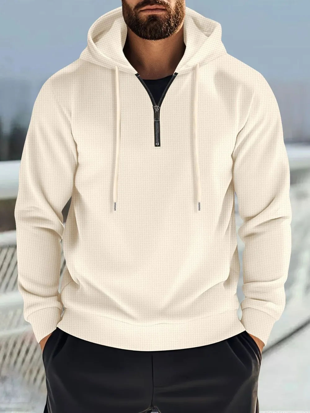 Beige waffle-knit quarter-zip hooded pullover with drawstring and black zipper.