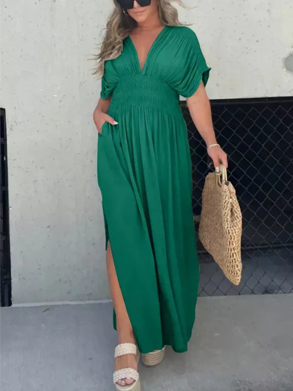 Green V-neck dolman sleeve maxi dress with smocked waist and side slits.