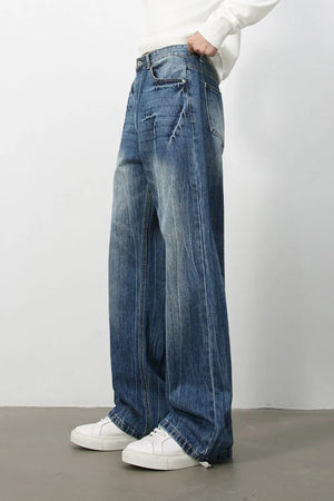 Wide-leg distressed denim jeans in vintage wash with a relaxed fit and frayed details.