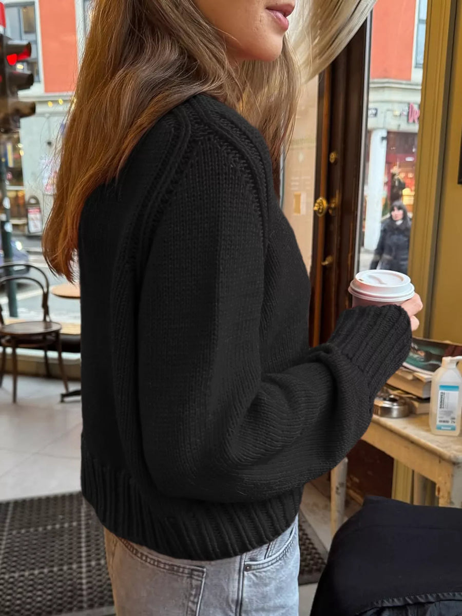 Black ribbed round-neck knit sweater with cuffed sleeves and hem