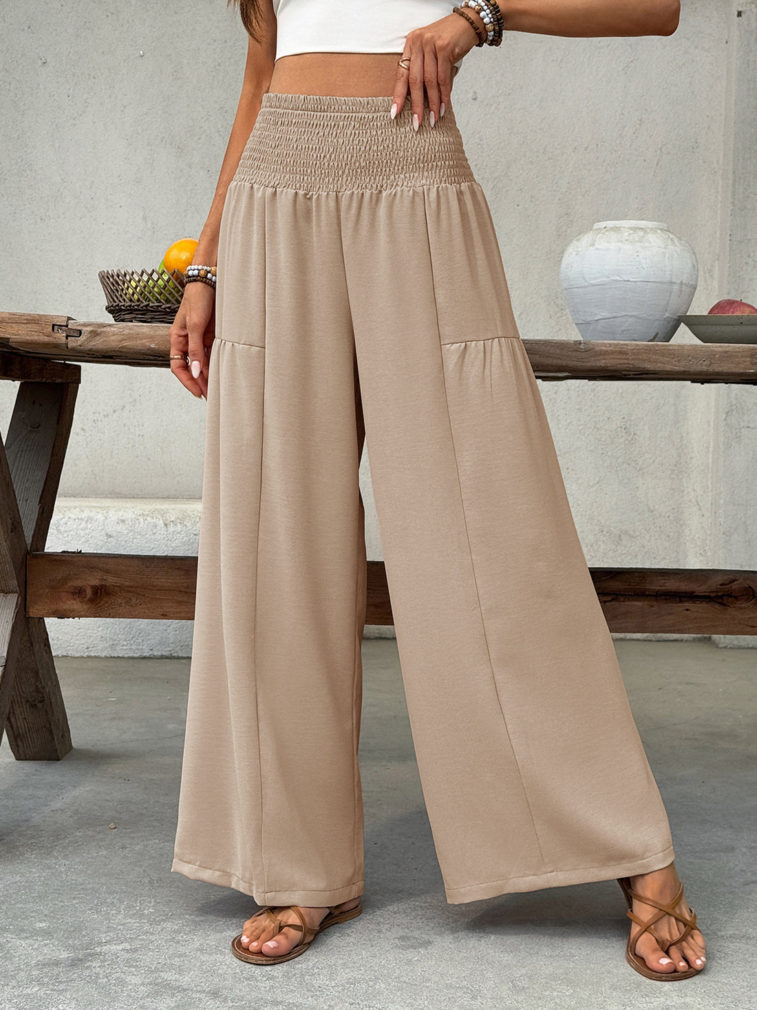 Smocked waist wide leg cotton pants in beige with a comfortable, casual fit.
