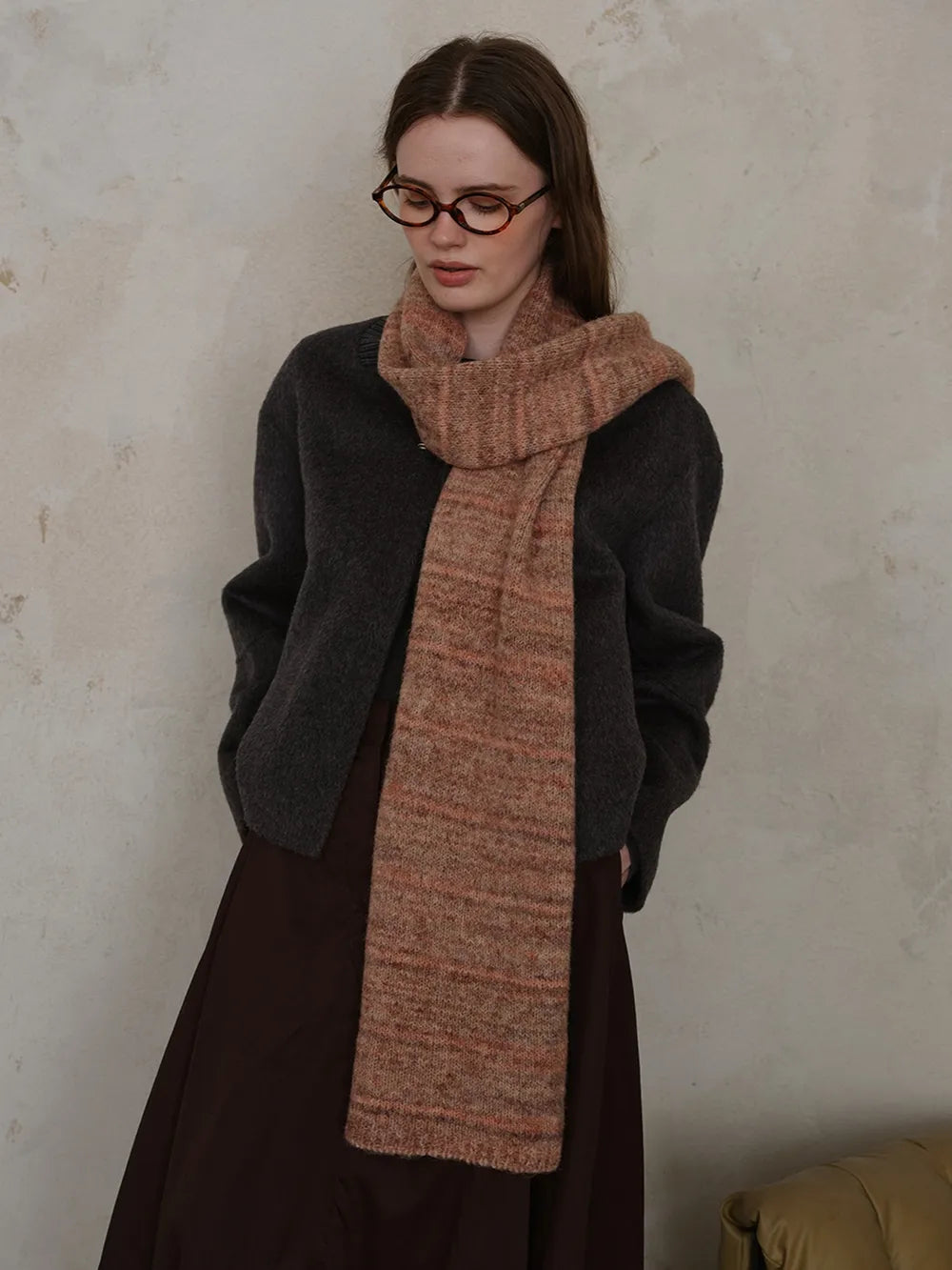 Textured mélange knit scarf in Terracotta with subtle pink and brown flecks, styled by a model.