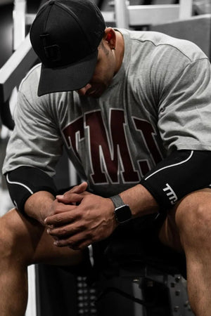Gray oversized graphic tee with athletic appeal and bold maroon lettering.