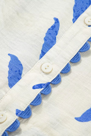 Maxi dress with blue botanical print, button front, and scalloped trim detail.