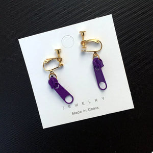 Purple zipper dangle clip-on earrings with gold-tone hardware.
