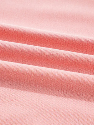 Oversized dusty pink sweatshirt with contrast stitching detail, showing textured fabric.