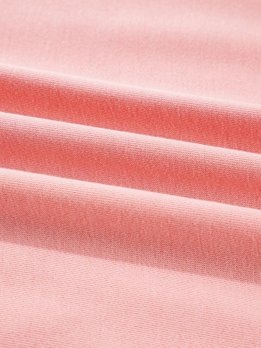 Oversized dusty pink sweatshirt with contrast stitching detail, showing textured fabric.