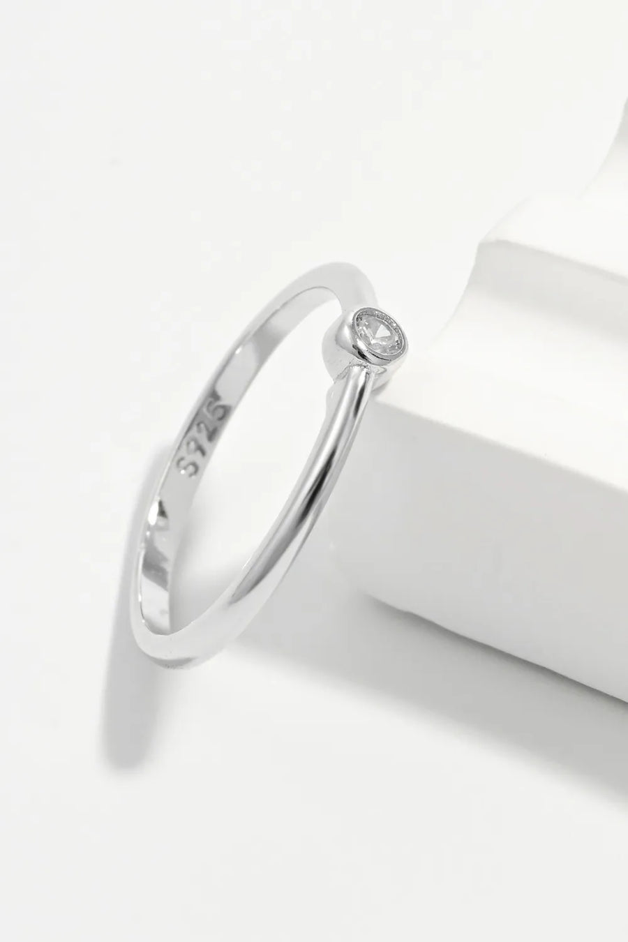 Solitaire silver ring with zirconia, 925 sterling silver band, minimalist design.