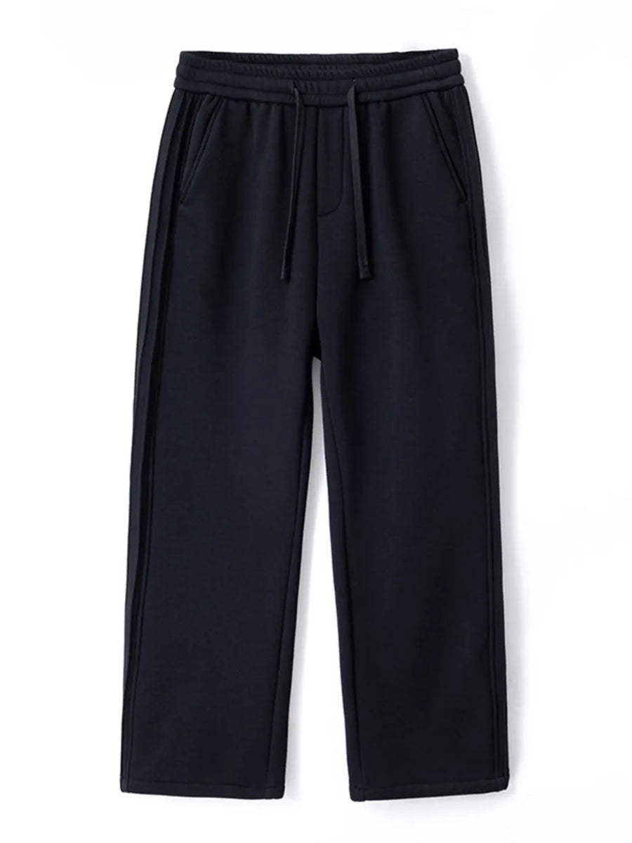 Black relaxed fit men's sweatpants with drawstring and side stripe detail.