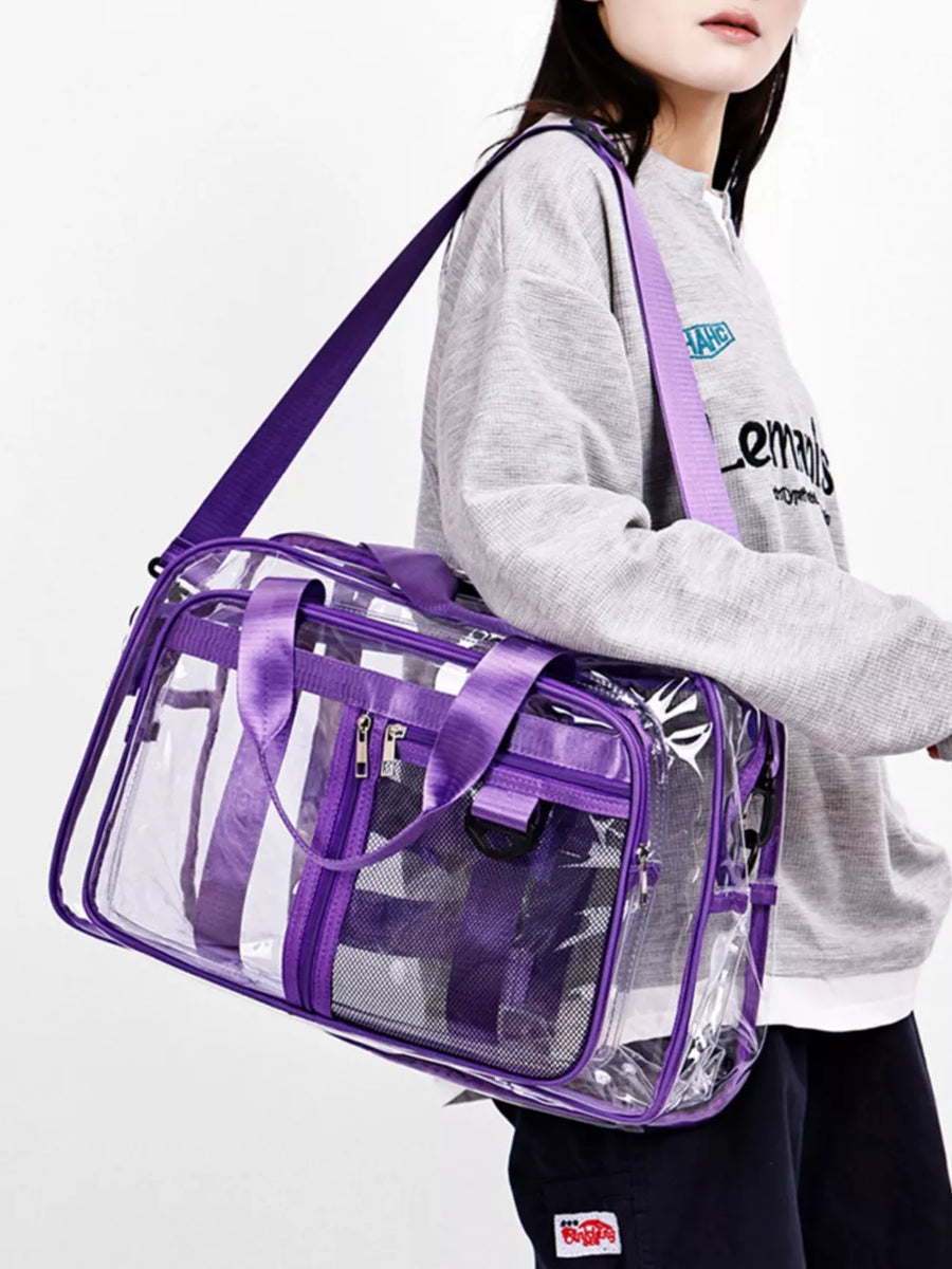 Clear duffel bag with purple trim and straps, featuring mesh pockets and dual zippers.