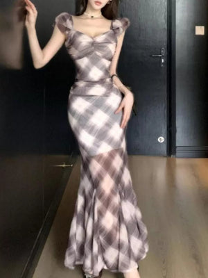 Ruched plaid bodycon maxi dress with sweetheart neckline and sheer flared hem.