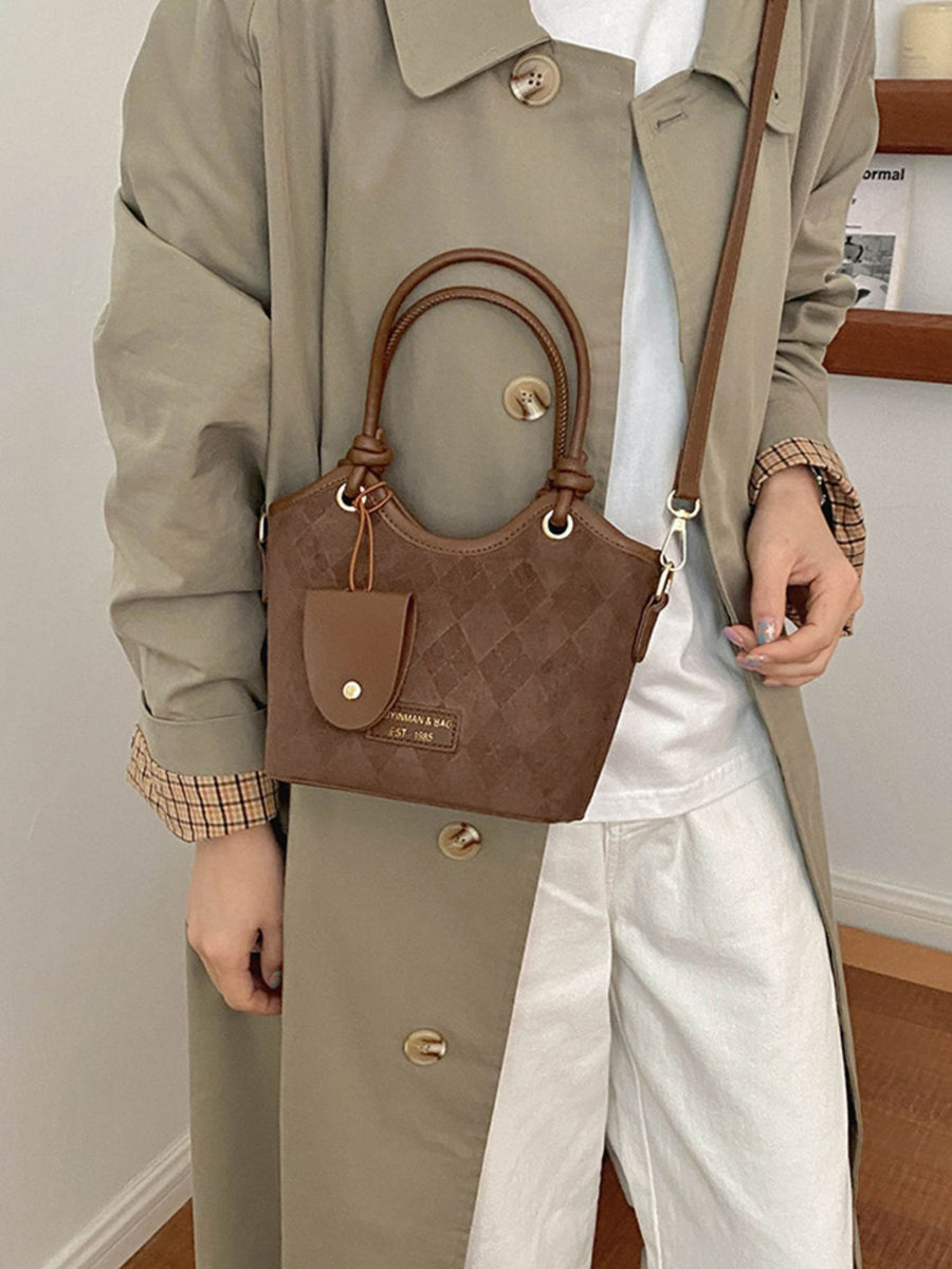 Brown crossbody bag featuring quilted and quilted