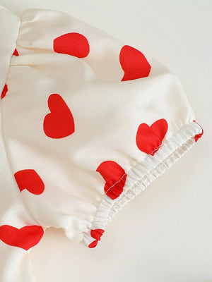 Baby dress with puff sleeves, white with red hearts, cotton fabric, elasticated cuffs.