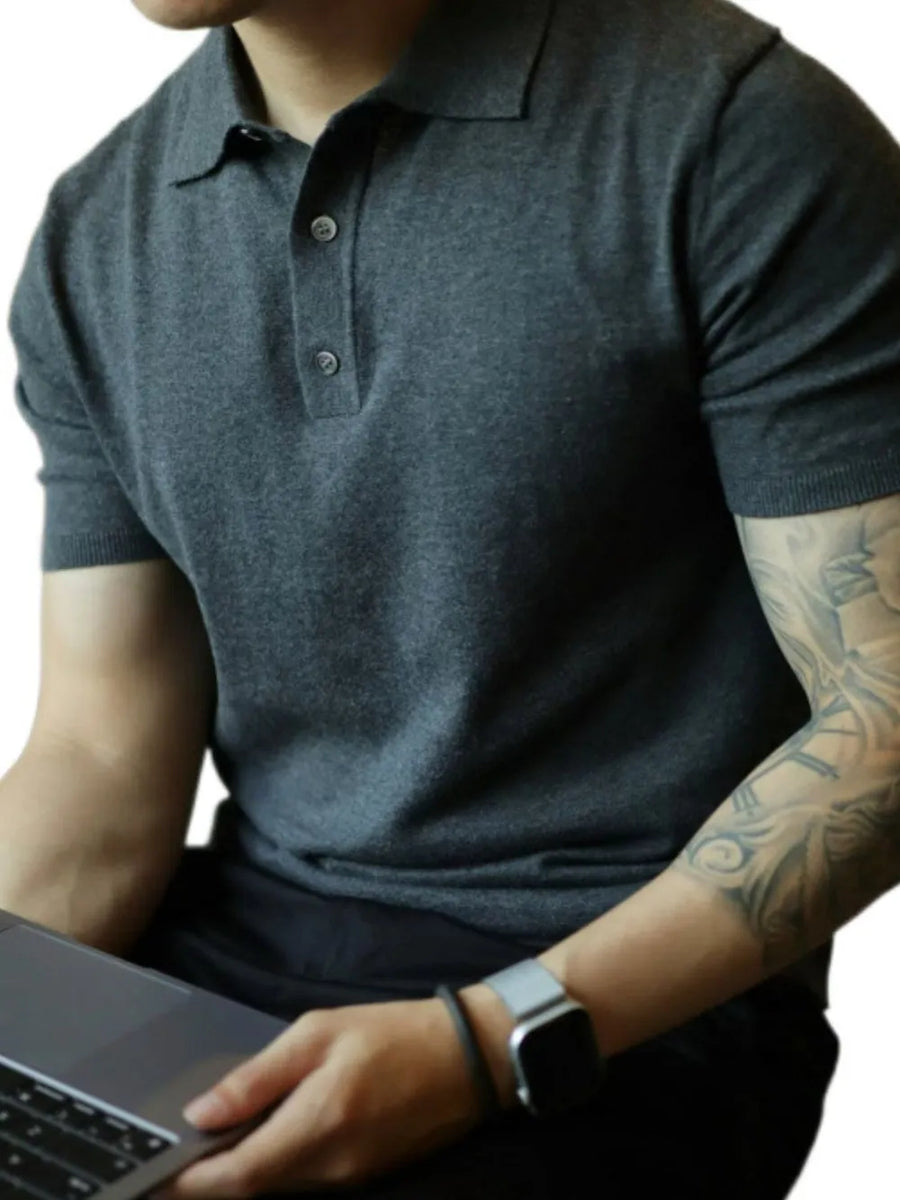 Dark gray fine-gauge knit polo shirt with a refined placket and button detail.