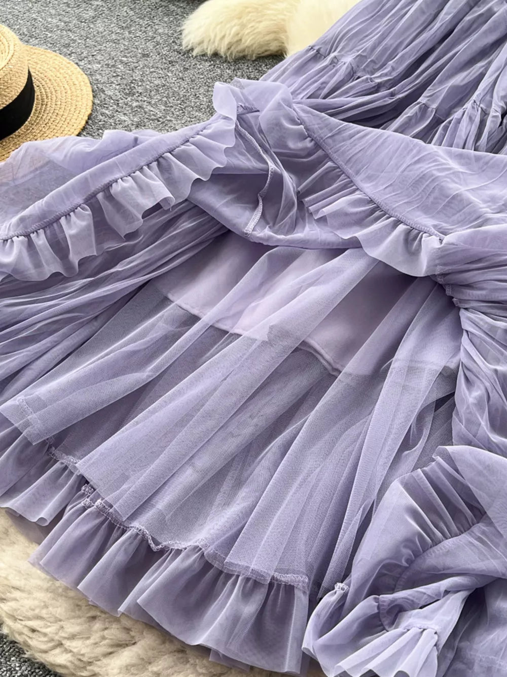 Purple tiered tulle skirt with ruffled hem and lining, shown from below.