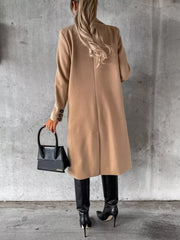 Chic double-breasted longline trench coat in apricot with button details.