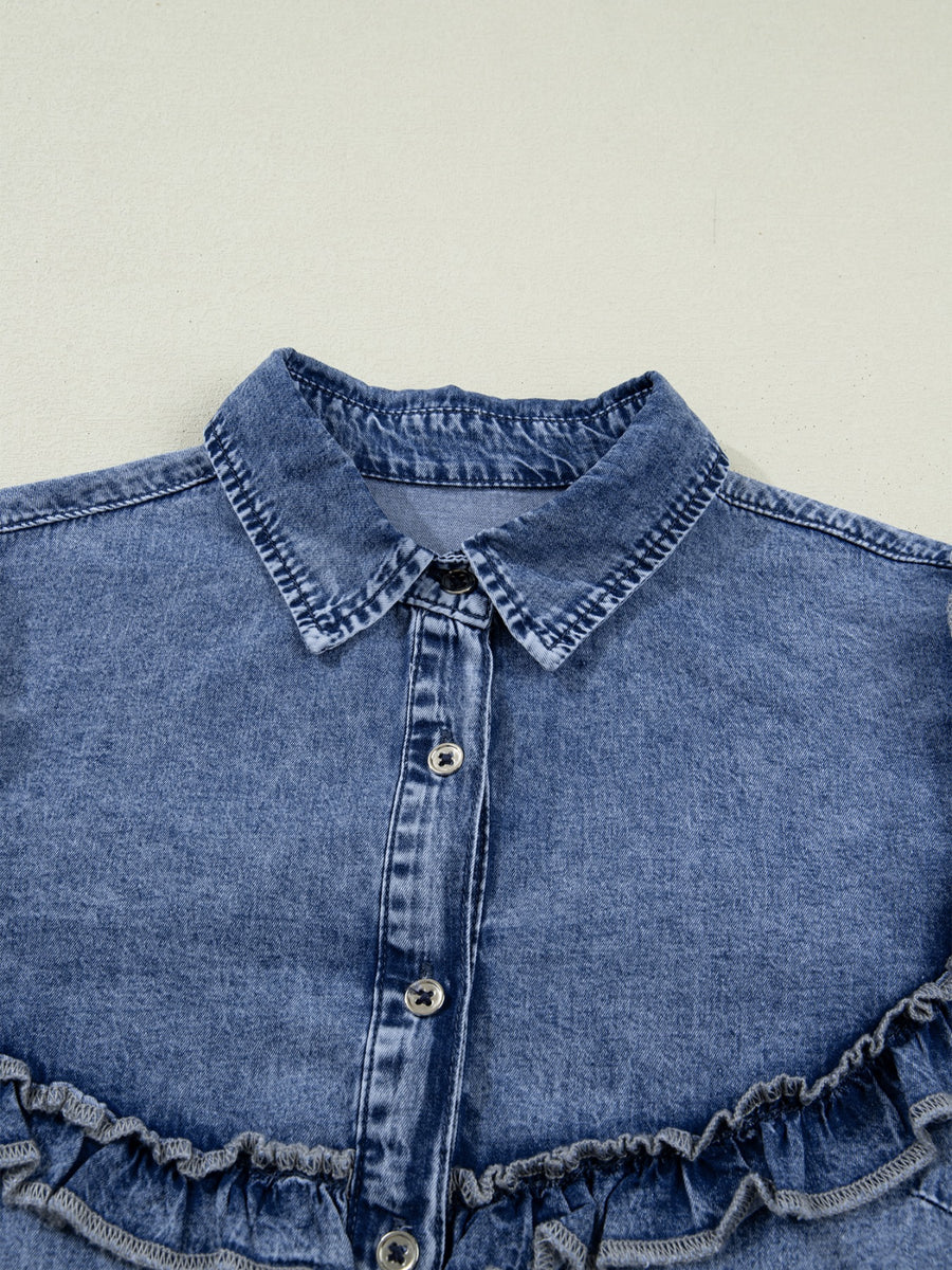 Vintage wash denim button-down shirt with ruffled hem and button front detail.