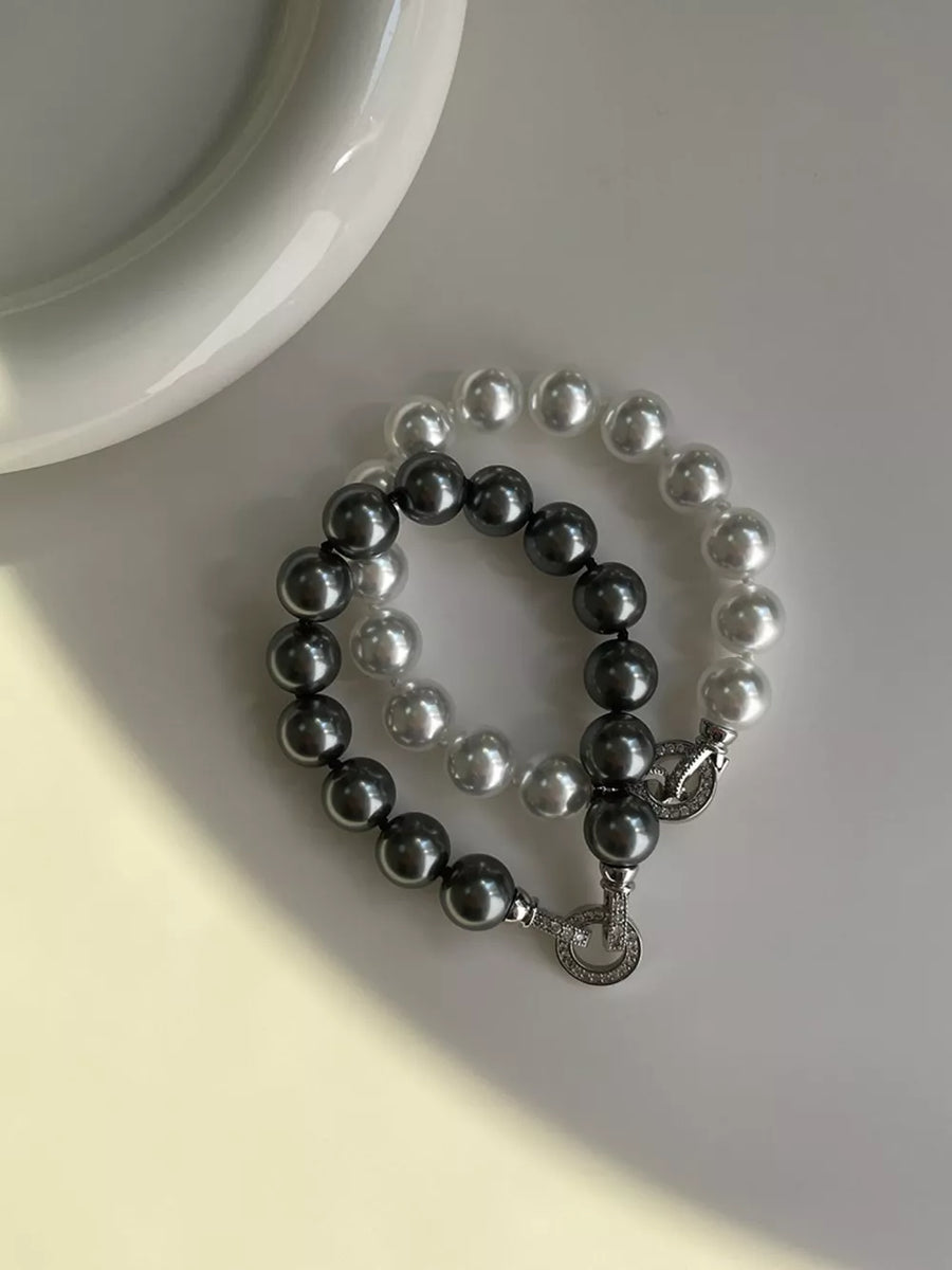 Elegant pearl beaded bracelet with clasp in dark gray and white, featuring alloy details.