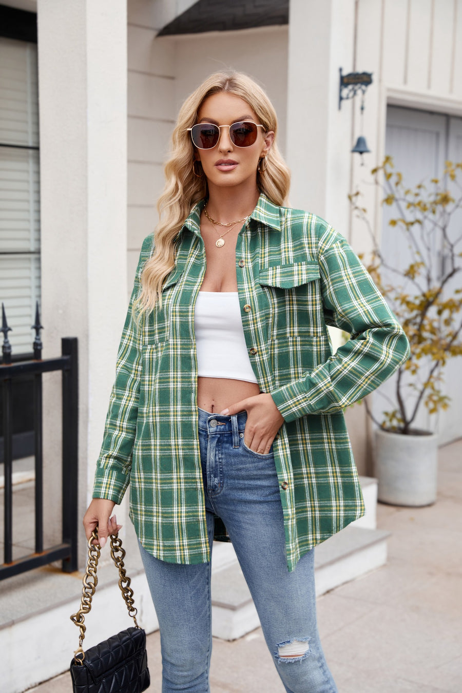 Green plaid overshirt with patch pockets and buttoned front, worn open over a white crop top.