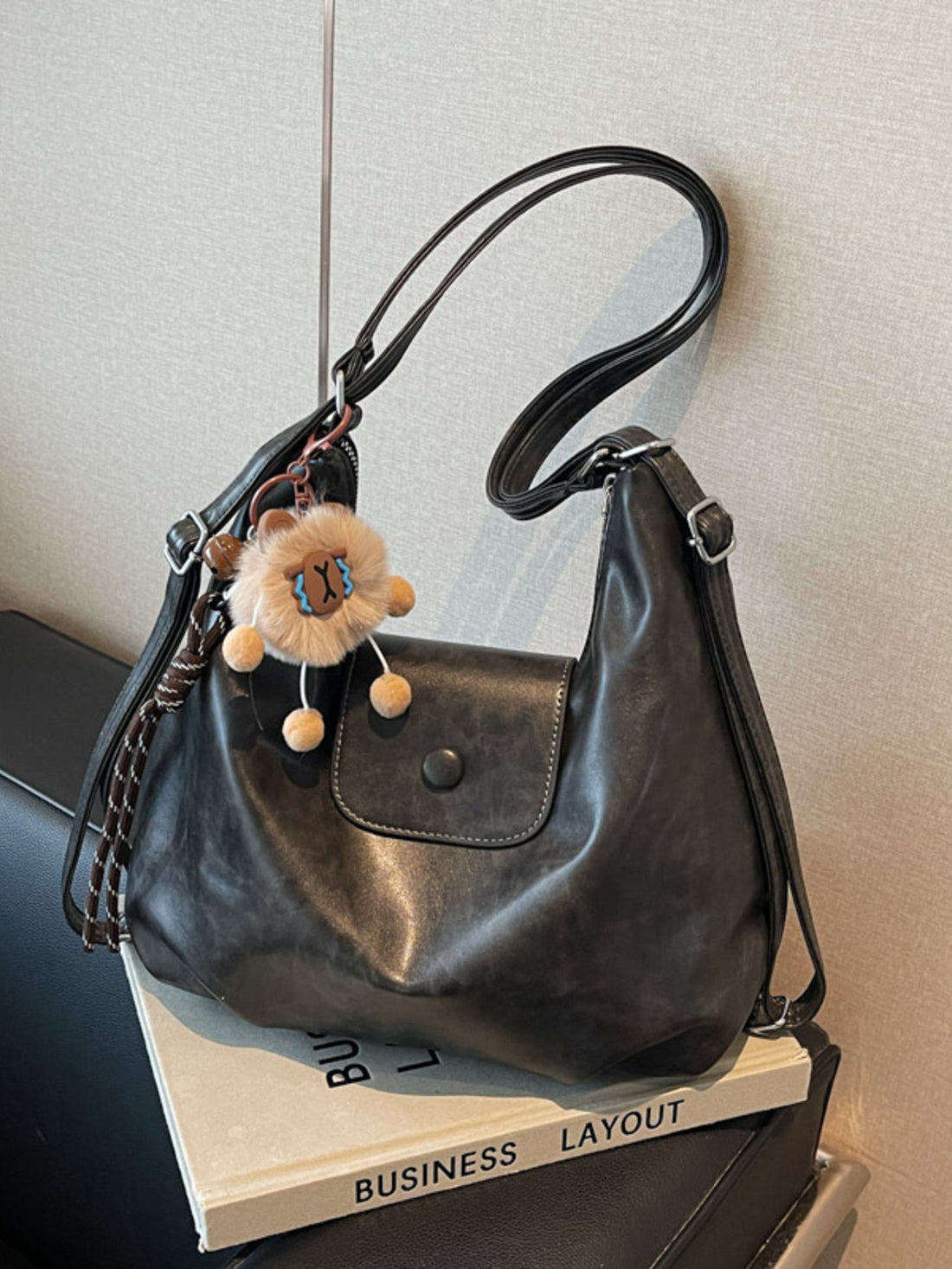 Black vintage pu leather shoulder bag with adjustable strap and lion charm